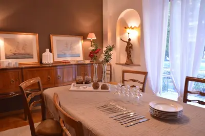 a dining room with a table with plates and wine glasses at Detached House 4km away from Acropolis & Riviera in Athens