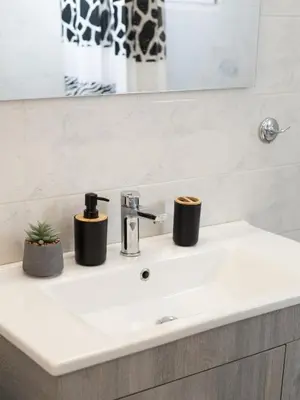 a bathroom sink with two candles on it at Roof Top Apartment By Athens Airport in Spáta