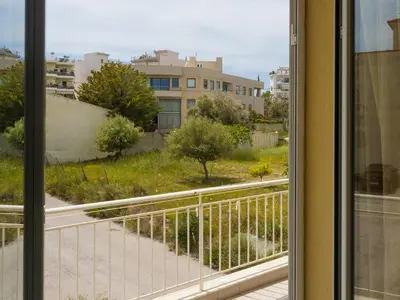 a view from a window of a balcony at Roof Top Apartment By Athens Airport in Spáta