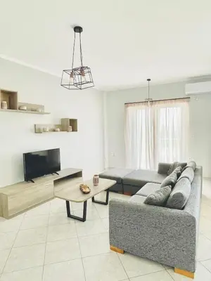a living room with a couch and a table at Roof Top Apartment By Athens Airport in Spáta
