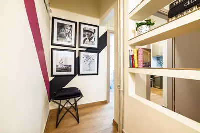 a hallway with pictures on the wall and a stool at Regal Studio Athens in Athens