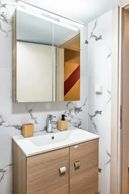 a bathroom with a sink and a mirror at Regal Studio Athens in Athens