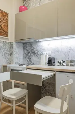a kitchen with white counters and white chairs at Regal Studio Athens in Athens