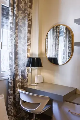 a desk in a room with a mirror and a chair at Regal Studio Athens in Athens
