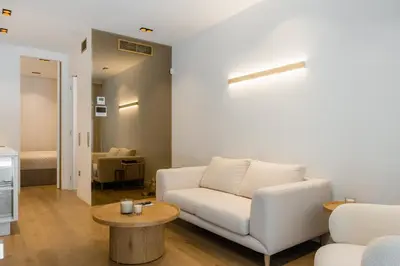 a living room with a white couch and a table at The Tone - Kolonaki in Athens
