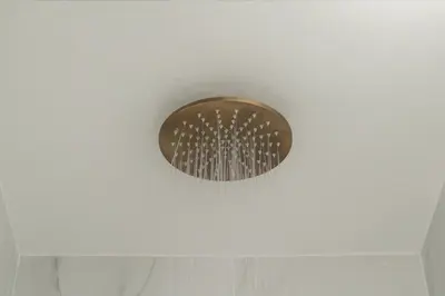 a round ceiling light in a white room at The Tone - Kolonaki in Athens
