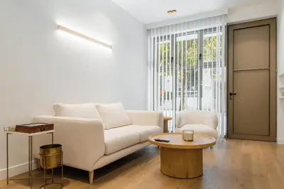 a living room with a couch and a table at The Tone - Kolonaki in Athens