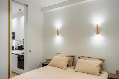 a bedroom with white walls and a bed with pillows at The Tone - Kolonaki in Athens