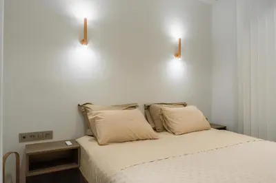 a bed with two pillows and two lights above it at The Tone - Kolonaki in Athens