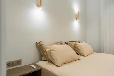 a bed with white sheets and pillows in a room at The Tone - Kolonaki in Athens
