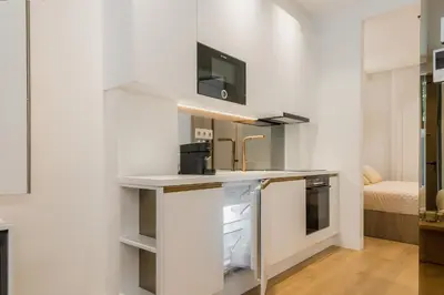 a kitchen with white walls and a white counter top at The Tone - Kolonaki in Athens