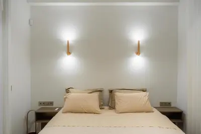 a bedroom with two lights above a bed at The Tone - Kolonaki in Athens