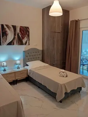 a bedroom with two beds and a large window at PARTHENON In HORIZON in Athens