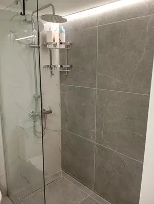 a bathroom with a shower with a glass door at PARTHENON In HORIZON in Athens