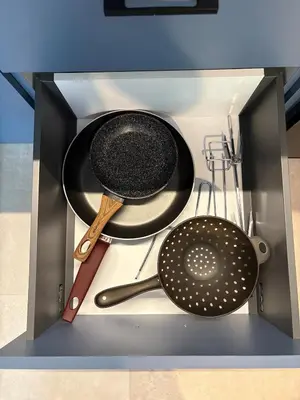 a cabinet with some utensils and pans in it at Relax adobe in central Athens in Athens