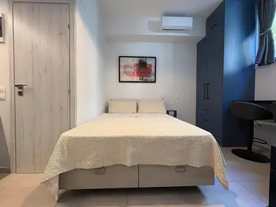 a bedroom with a bed and a blue wall at Relax adobe in central Athens in Athens