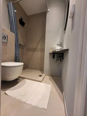 a bathroom with a white toilet and a sink at Relax adobe in central Athens in Athens