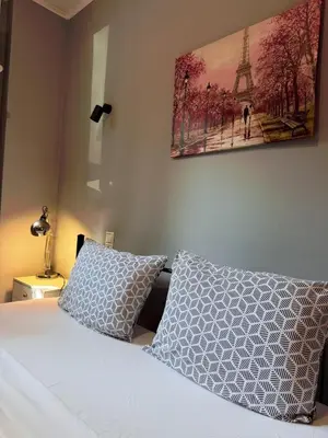 a bedroom with a bed and a picture of the eiffel tower at The Kallithea Spot Studio 1 in Athens