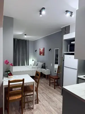 a kitchen and living room with a table and chairs at The Kallithea Spot Studio 1 in Athens