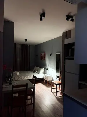 a bedroom with a bed and a table and chairs at The Kallithea Spot Studio 1 in Athens