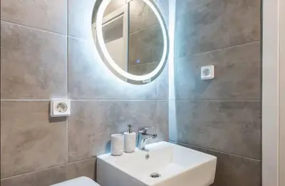 a bathroom with a sink and a mirror at The Kallithea Spot Studio 1 in Athens