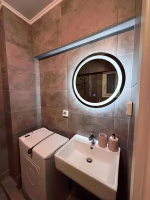 a bathroom with a toilet and a sink and a mirror at The Kallithea Spot Studio 1 in Athens