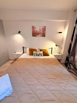 a bedroom with a large bed with two tables at The Kallithea Spot Studio 2 in Athens