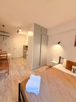 a large room with a bed and a table at The Kallithea Spot Studio 2 in Athens
