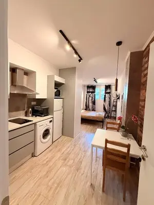 a kitchen and living room with a table and chairs at The Kallithea Spot Studio 2 in Athens