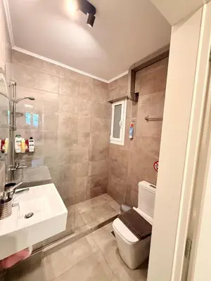 a bathroom with a toilet and a sink at The Kallithea Spot Studio 2 in Athens