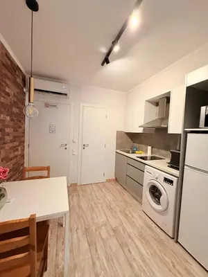 a kitchen with a washer and dryer in a room at The Kallithea Spot Studio 2 in Athens
