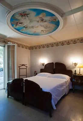 a bedroom with a large bed with a painting on the ceiling at Villa Lagonisi, magnificent Villa in the Athenian Riviera in Áyios Nikólaos