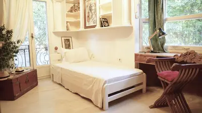 a bedroom with a bed and a desk and windows at Villa Lagonisi, magnificent Villa in the Athenian Riviera in Áyios Nikólaos