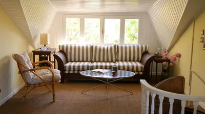 a living room with a couch and a table at Villa Lagonisi, magnificent Villa in the Athenian Riviera in Áyios Nikólaos