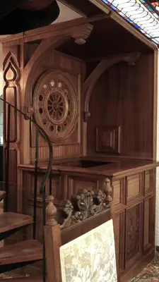a wooden cabinet with a clock in a room at Villa Lagonisi, magnificent Villa in the Athenian Riviera in Áyios Nikólaos