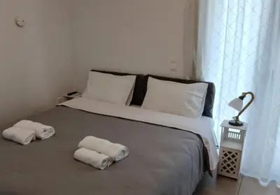 a bedroom with a bed with two towels on it at Akrivis studio in Athens