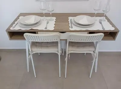 a dining room table with two chairs and plates and wine glasses at Akrivis studio in Athens