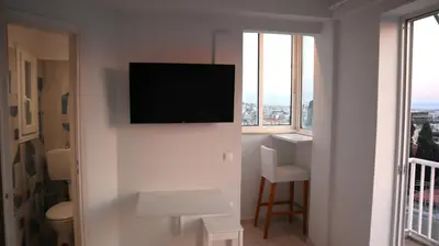 a room with a flat screen tv on a wall at A room with a view in Athens