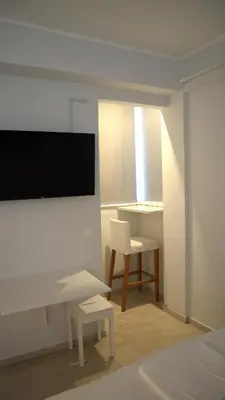 a white room with a desk and a chair at A room with a view in Athens