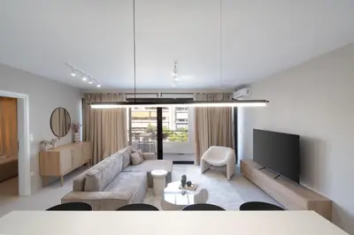 a living room with a couch and a tv at LIV - Deluxe 2BD Apartment in Athens in Athens