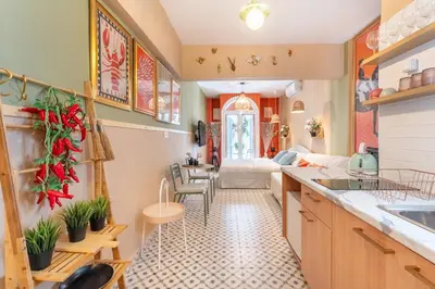 a kitchen and living room with a couch and a table at Chilli & Chill in Athens