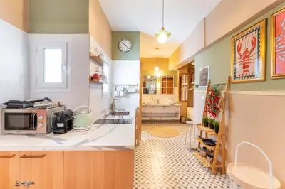two views of a kitchen with a microwave and a bathroom at Chilli & Chill in Athens