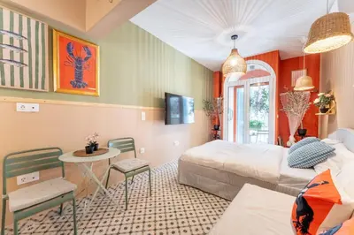 a bedroom with two beds and a table and chairs at Chilli & Chill in Athens