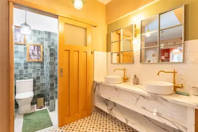 a bathroom with two sinks and a toilet at Chilli & Chill in Athens