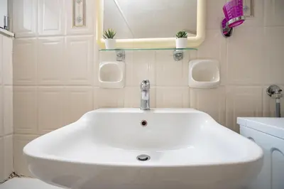 a bathroom with a white sink and a mirror at Chic 2-Bdrm Oasis in Pangrati by ΜΡS in Athens