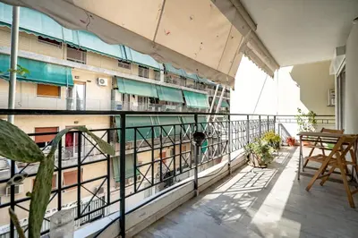 a balcony of a building with a table and chairs at Chic 2-Bdrm Oasis in Pangrati by ΜΡS in Athens