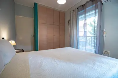 a bedroom with a large white bed and a window at Chic 2-Bdrm Oasis in Pangrati by ΜΡS in Athens
