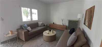 a living room with a couch and a table at Archontiko Voulas D in Athens