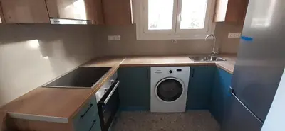 a small kitchen with a washing machine in the counters at Archontiko Voulas D in Athens