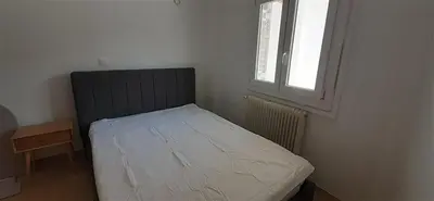 a small bed in a room with a window at Archontiko Voulas D in Athens